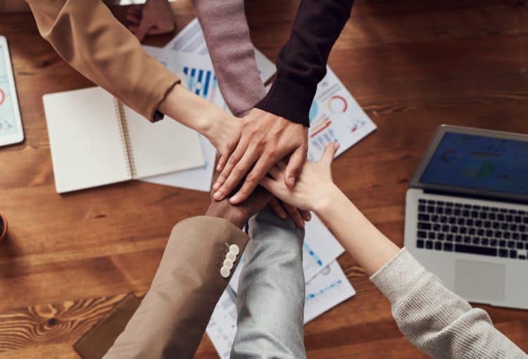A group of people with their hands in a circle