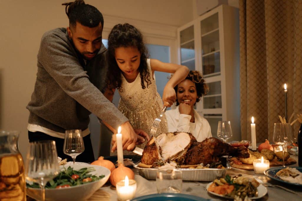 A family displaying a thankful mindset by gathering around the table