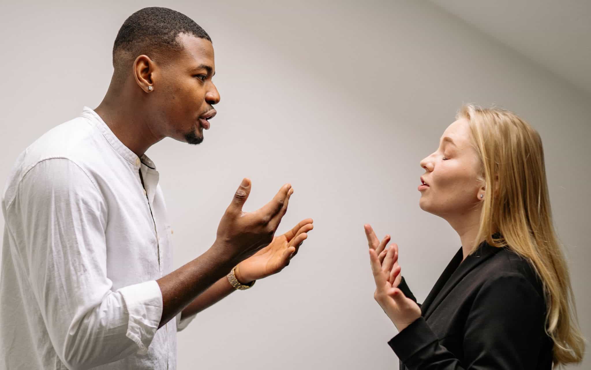 two people yelling at each other. This is an example of conflict in the workplace.