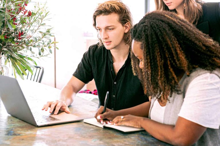 Two people looking at a computer