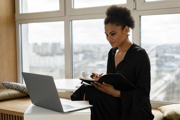 a person sitting at a desk typing on their computer