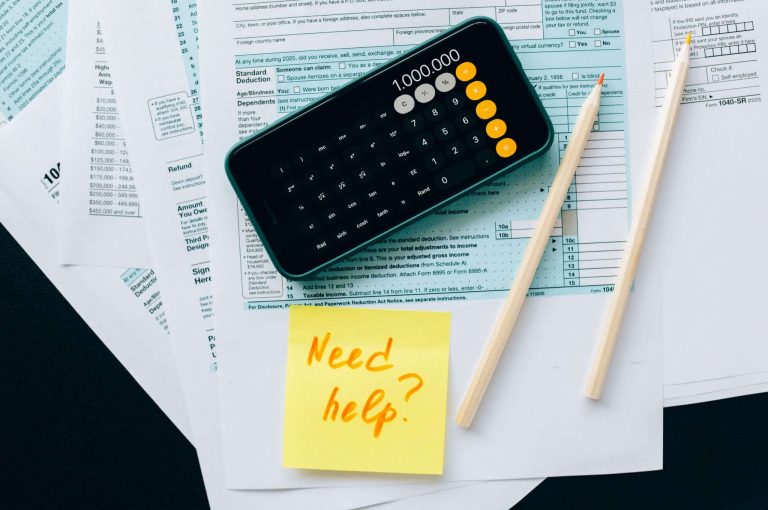 A pile of financial paperwork and a calculator